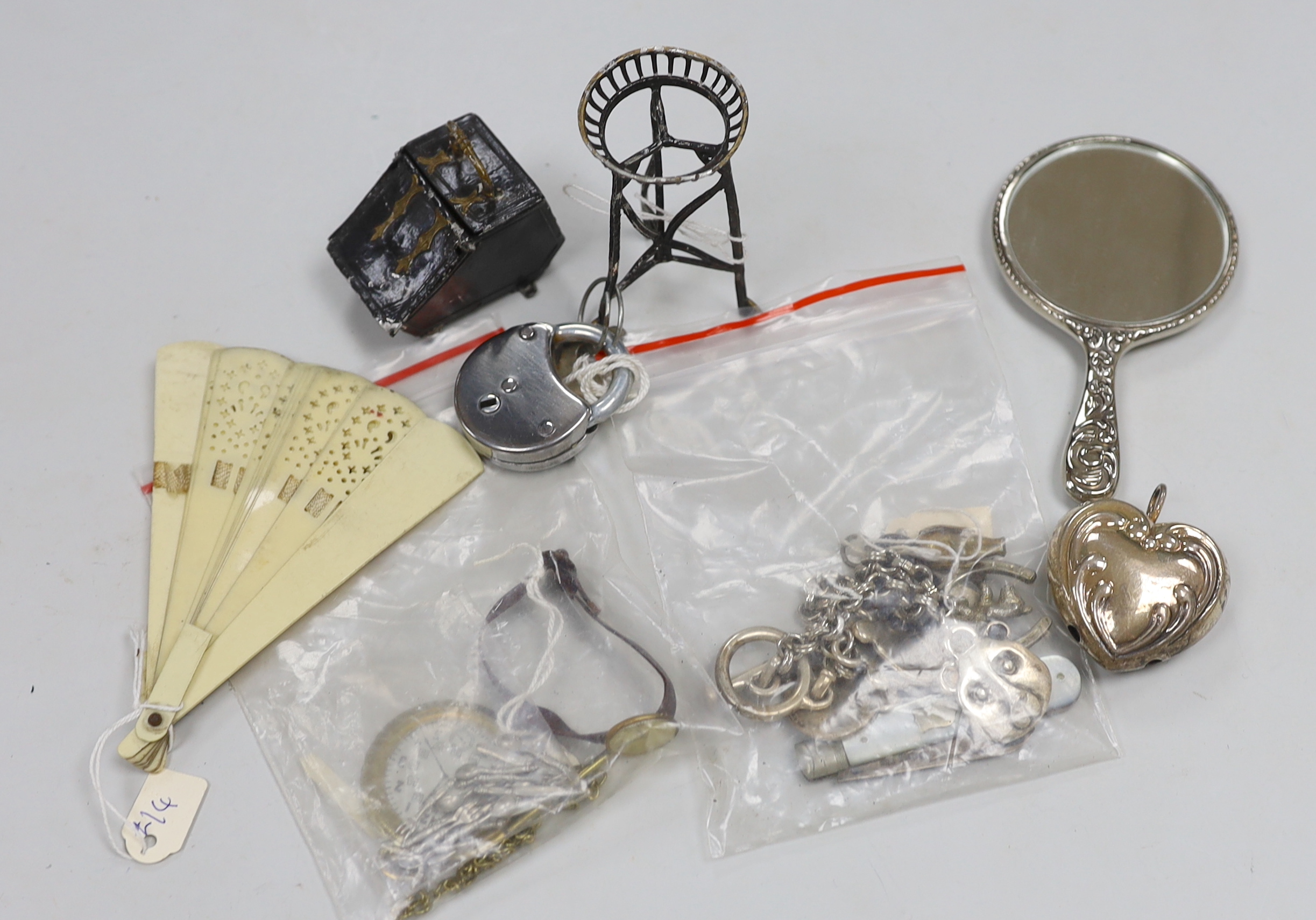 A silver penknife, a metal teddy bear bracelet, a vintage teddy bear pocket watch, a watch, a doll's house coal scuttle, a lock, a fan, a small hand mirror and doll's house cutlery